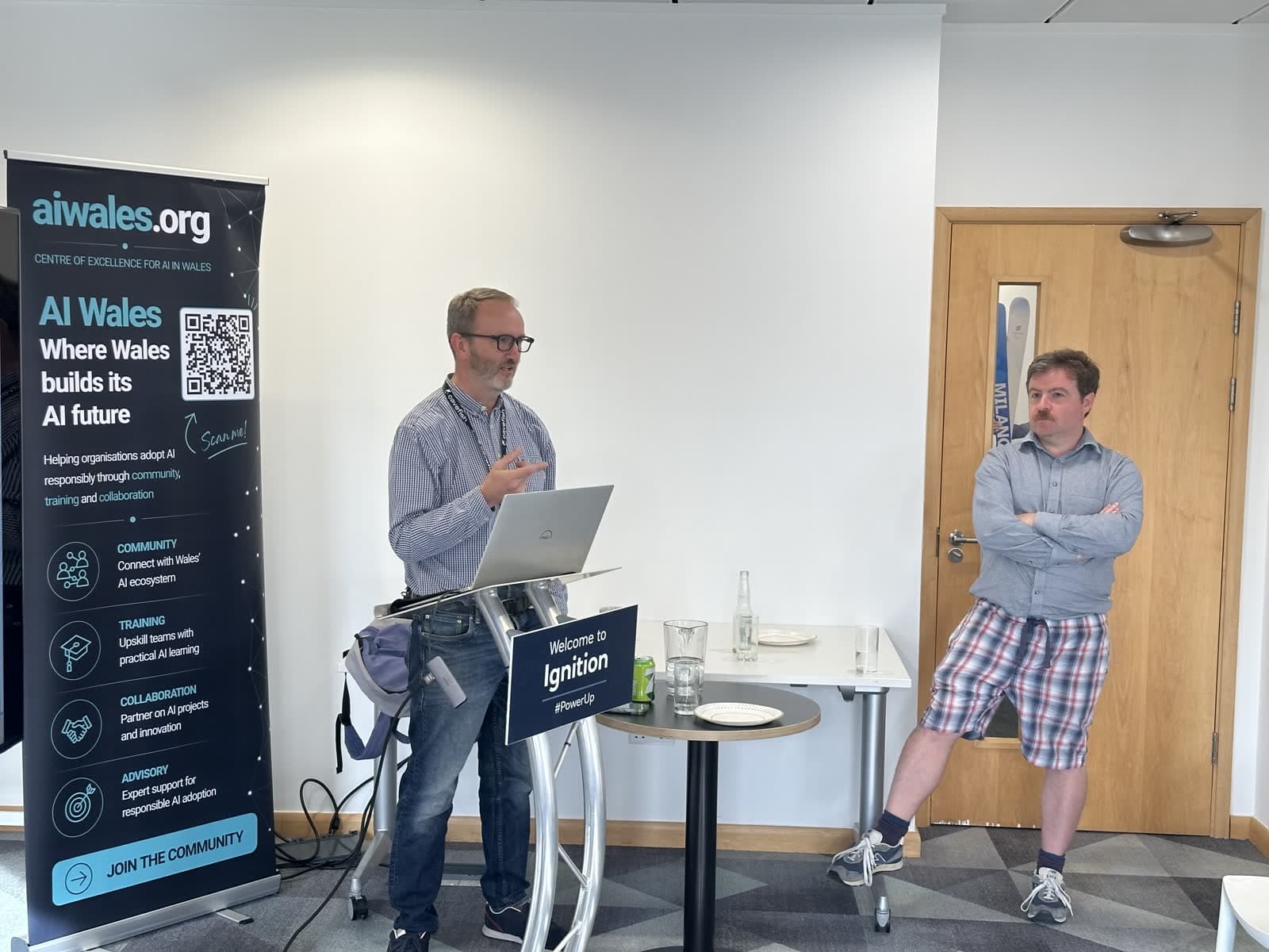 Speaker presenting alongside the AI Wales banner at AI Build: Show and Tell