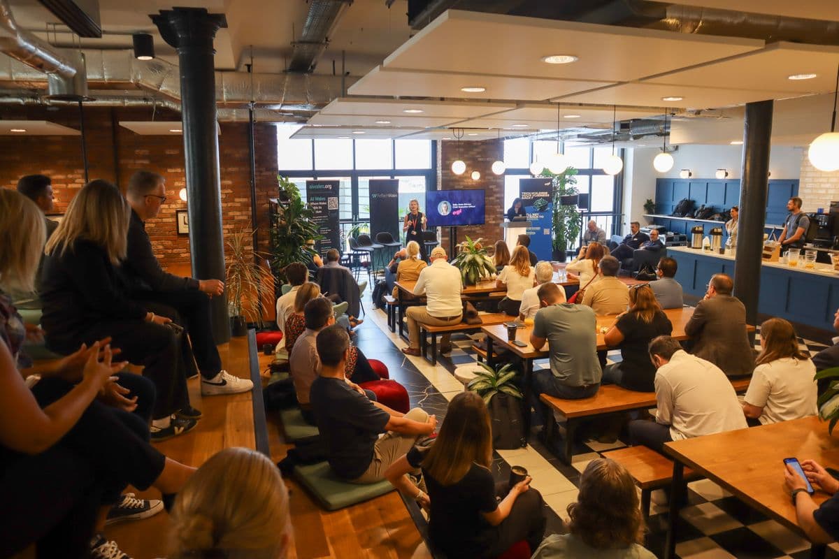 Speaker presenting at AI Hub Launch with Fintech Wales branding at Hodge House Cardiff