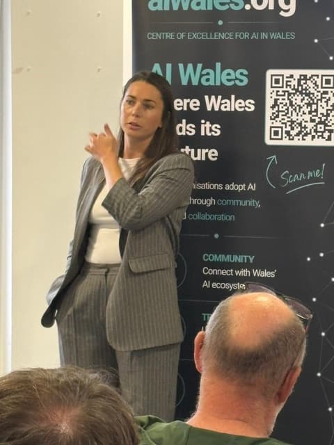 Speaker presenting at What Employers Are Really Looking For with the AI Wales banner